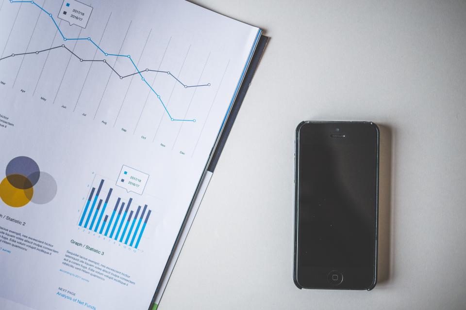 Image of charts and smartphone.